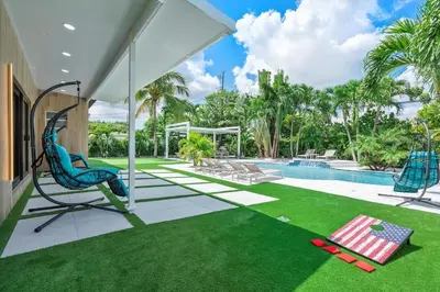 a house with a yard with a pool and grass at VillaLee-Jungle Palm Island white marble pool Area in Miami