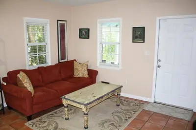 a living room with a couch and a coffee table at Key West Style Historic Home in Coconut Grove Florida, The Blue House in Miami