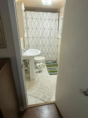 a bathroom with a white toilet and a sink at Key West Style Historic Home in Coconut Grove Florida, The Blue House in Miami