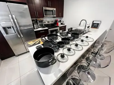 a kitchen counter with many pots and pans on it at Vacay Spot experience Luna Sky! 65