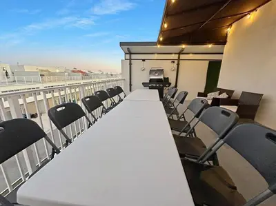 a room with chairs and a table on a balcony at Vacay Spot experience Luna Sky! 65