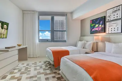 a hotel room with two beds and a television at Ocean Front State Of The Art in Hollywood