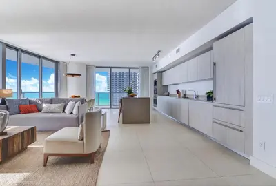 a kitchen and living room with a couch and a table at Ocean Front State Of The Art in Hollywood