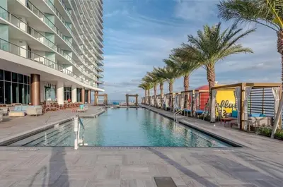 a swimming pool in the middle of a building with palm trees at Zen Vacation Rentals Ocean front 3 3 MAZAL in Hollywood