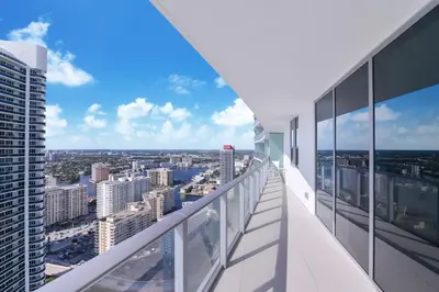 a balcony with a view of a city at Zen Direct Ocean Front Deluxe 3-Bedroom in Hollywood