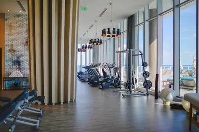 a gym with a row of treadmills and machines at Zen Direct Ocean Front Deluxe 3-Bedroom in Hollywood