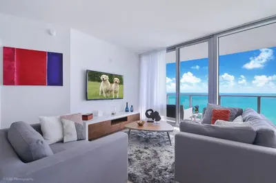 a living room with two couches and a view of the ocean at Zen Direct Ocean Front Deluxe 3-Bedroom in Hollywood
