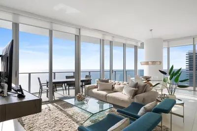 a living room with a couch and a table at Zen Luxury Resort Ocean Front Penthouse in Hollywood