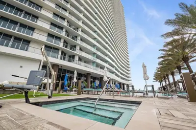 a swimming pool in front of a building at Zen Luxury Resort Ocean Front Penthouse in Hollywood