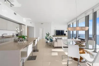a kitchen and living room with a table and chairs at Zen Luxury Resort Ocean Front Penthouse in Hollywood