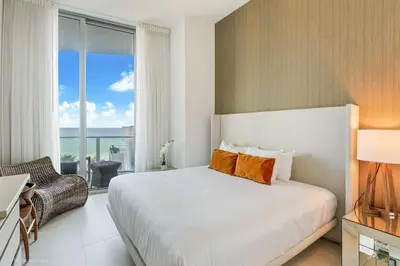 a bedroom with a bed and a large window at Zen Vacation Rentals Direct Ocean Front Low Floor in Hollywood