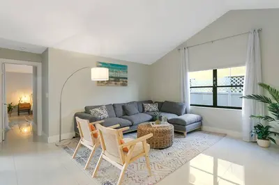 a living room with a couch and a table and chairs at Citrus+Sunshine/Heated Pool/6 min to Beach/Casino in Dania Beach