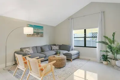 a living room with a couch and a table and chairs at Citrus+Sunshine/Heated Pool/6 min to Beach/Casino in Dania Beach