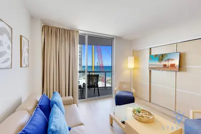 a living room with a couch and a table at Beachfront Resort - Pool - Ocean View Balcony- Gym in Miami Beach