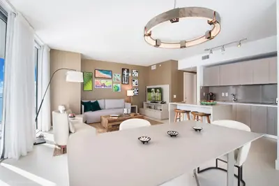 a kitchen and living room with a white table and chairs at Zen Vacation Rentals Ocean Front at Lyfe Resort in Hollywood