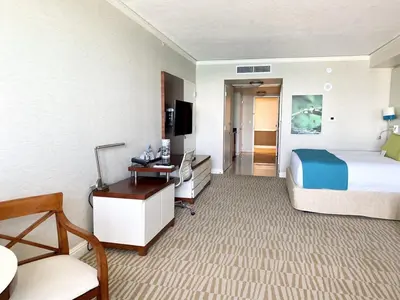 a large hotel room with a bed and a desk at Trump International Resort by Zen Vacation Rentals in Miami Beach