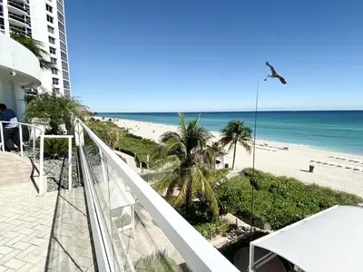 a balcony with a view of the beach at Trump International Resort by Zen Vacation Rentals in Miami Beach