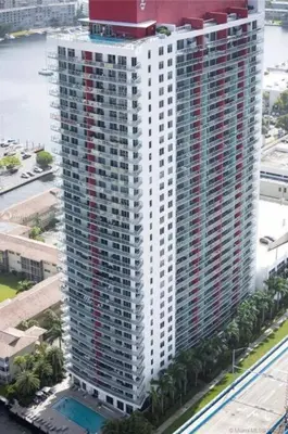 an aerial view of a tall building with palm trees at Luxury Stay in Miami Beach Stunning Views & Full Kitchen 20A in Hallandale Beach