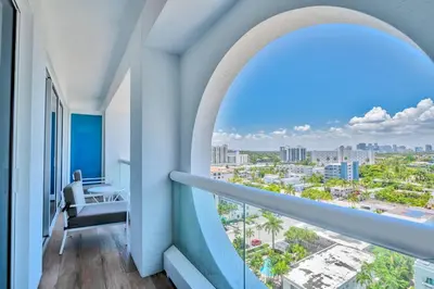 a room with a balcony with a view of a city at Luxury 1 BR Suite at Fort Lauderdale in Fort Lauderdale