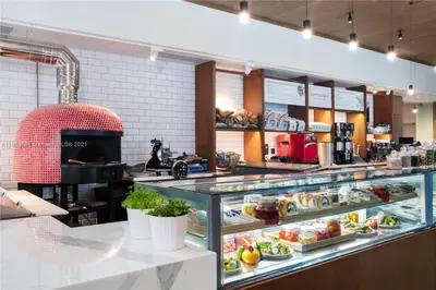 a display case in a bakery with a lot of food at Luxury 1 BR Suite at Fort Lauderdale in Fort Lauderdale