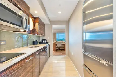 a kitchen with a sink and a refrigerator at Luxury 1 BR Suite at Fort Lauderdale in Fort Lauderdale