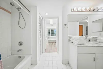 a white bathroom with a tub and a sink at Amazing 1 Bed 1 Bath • Brickell • City & Bay View in Miami