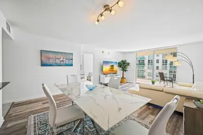 a living room with a glass table and chairs at Amazing 1 Bed 1 Bath • Brickell • City & Bay View in Miami