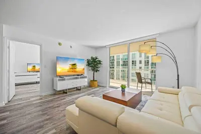 a living room with a white couch and a tv at Amazing 1 Bed 1 Bath • Brickell • City & Bay View in Miami