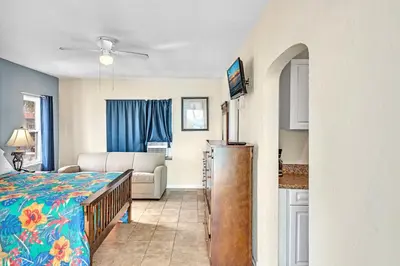 a bedroom with a bed and a living room at Charter House in Hollywood