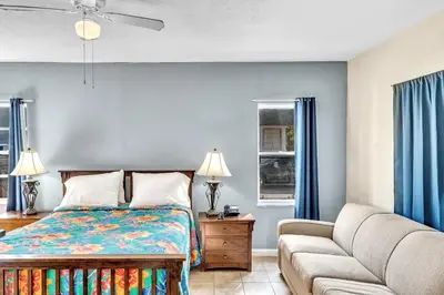a bedroom with a bed and a couch at Charter House in Hollywood