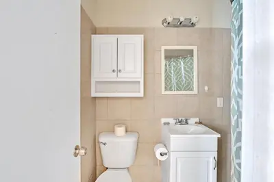 a small bathroom with a toilet and a sink at Charter House in Hollywood