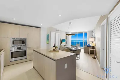 a kitchen and living room with a view of the ocean at Insane Ocean View Balcony - Beachfront Condo - Pool in Hollywood