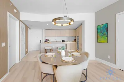 a kitchen and dining room with a table and chairs at Insane Ocean View Balcony - Beachfront Condo - Pool in Hollywood