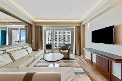 a living room with a couch and a flat screen tv at Luxury Suite at Fort Lauderdale in Fort Lauderdale
