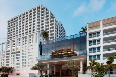 a large white building with palm trees in front of it at Luxury Suite at Fort Lauderdale in Fort Lauderdale