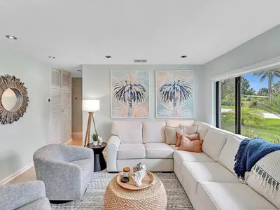 a living room with a white couch and a table at Walk 2 Wilton! Heatd Pool & 10 min to Bch Las Olas in Fort Lauderdale