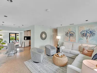 a living room with a white couch and chairs at Walk 2 Wilton! Heatd Pool & 10 min to Bch Las Olas in Fort Lauderdale
