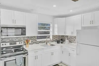 a white kitchen with white cabinets and a refrigerator at Hollywood Vacation In Perfect Beach Location Ha01 in Hollywood