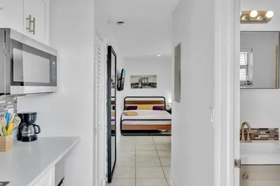 a kitchen and a bedroom with a bed in a room at Large 2 Bed Studio Close to Beach & Hard Rock HA03 in Hollywood