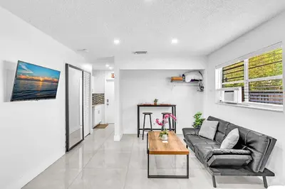 a living room with a couch and a table at New 2 Bed Studio Close To Beach & Casino Ha04 in Hollywood