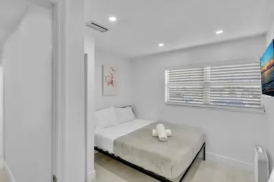 a white bedroom with a bed and a window at NEW 2 Bedroom Hollywood Beach and Hard Rock LB1 in Hollywood
