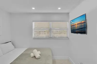 a white room with a bed and a window at NEW 2 Bedroom Hollywood Beach and Hard Rock LB1 in Hollywood