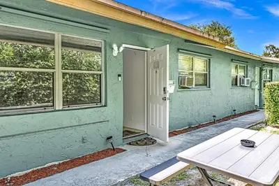 a green house with a picnic table in front of it at Hollywood 2 Bdrm New Furnished Beach Vacation LB2 in Hollywood