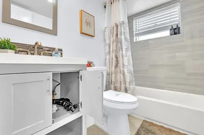 a white bathroom with a toilet and a bath tub at Hollywood Large Studio Close to Beach & Casino LB3 in Hollywood