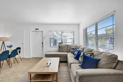 a living room with a couch and a table at Waves On Desoto Rental Unit With Pool in Hollywood