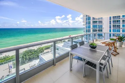 a balcony with a table and a view of the ocean at Monte Carlo by Miami Vacations in Miami Beach