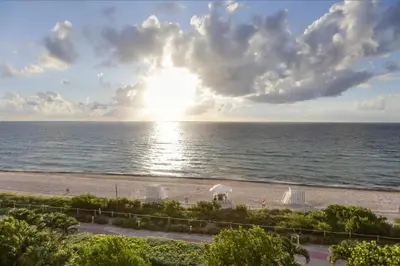 a view of the beach from the balcony of a resort at Monte Carlo by Miami Vacations in Miami Beach