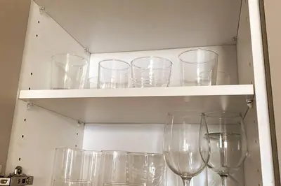 a bunch of wine glasses sitting on shelves at Elegant Miami Beach Apt Ocean Views, Full Kitchen & Style in Hallandale Beach