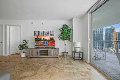 a living room with a television and a large window at PH Luxury 1 Bed 1 Bath • Brickell • Ocean Views in Miami