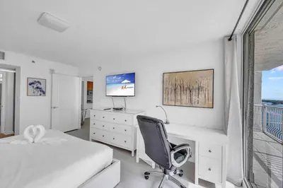 a bedroom with a desk and a bed and a chair at Deluxe 1 Bedroom Apartment • Brickell • Ocean View in Miami